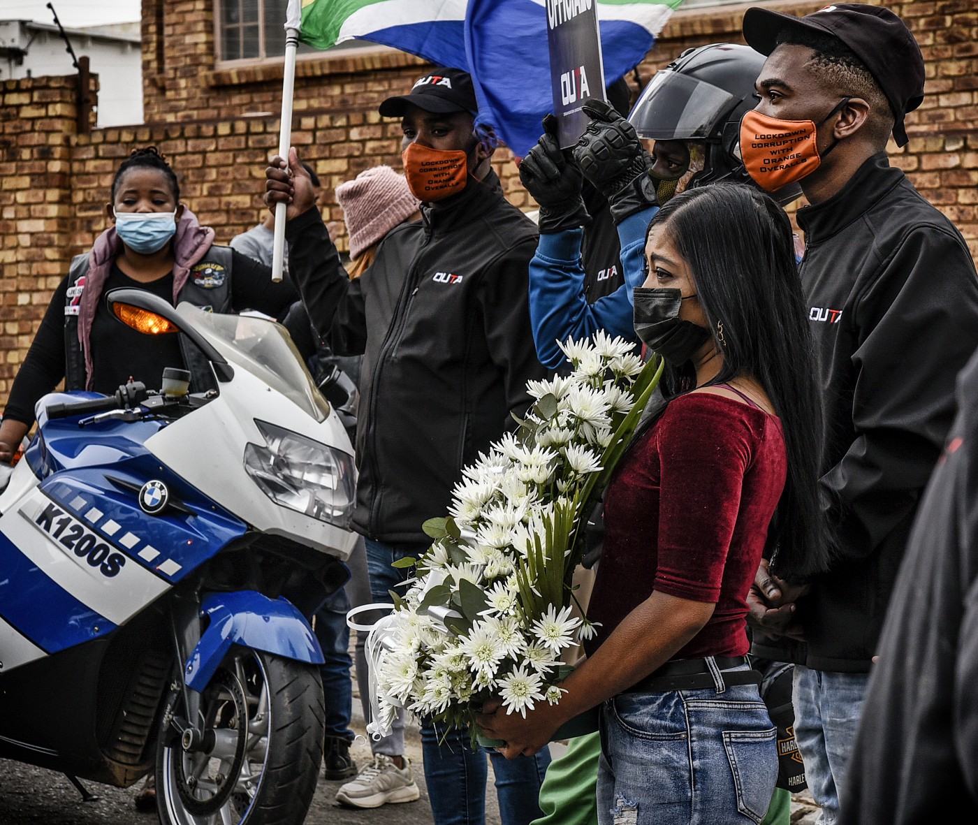 Bikers for Whistleblowers hand over a wreath to a relative of Babita Deokoran. Photo Stan Sher